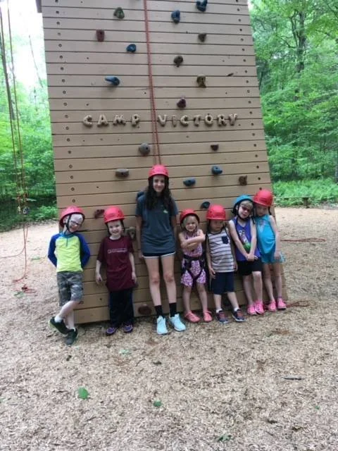 Camp Victory campers gathered in front of the Camp Victory climbing wall